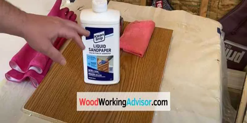 Bottle of liquid sandpaper deglosser on a wood surface