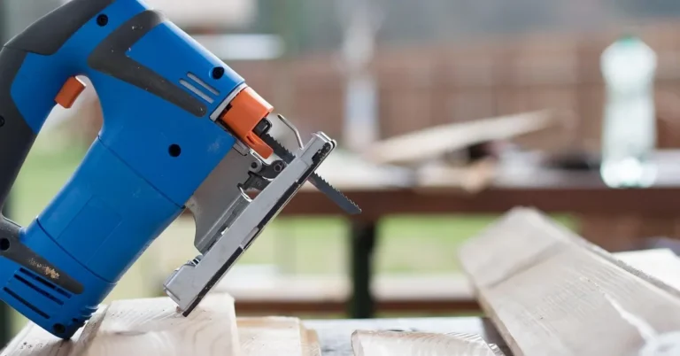 Jigsaw resting on lumber boards on an outdoor work table