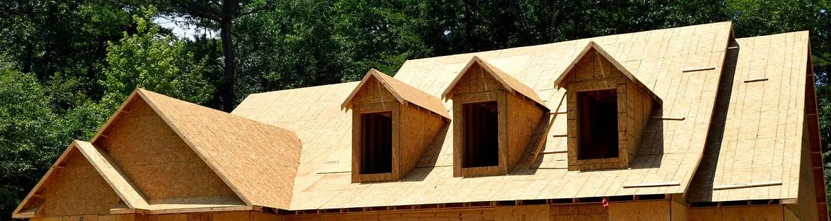 OSB roof sheathing panels installed over rafters on a house under construction