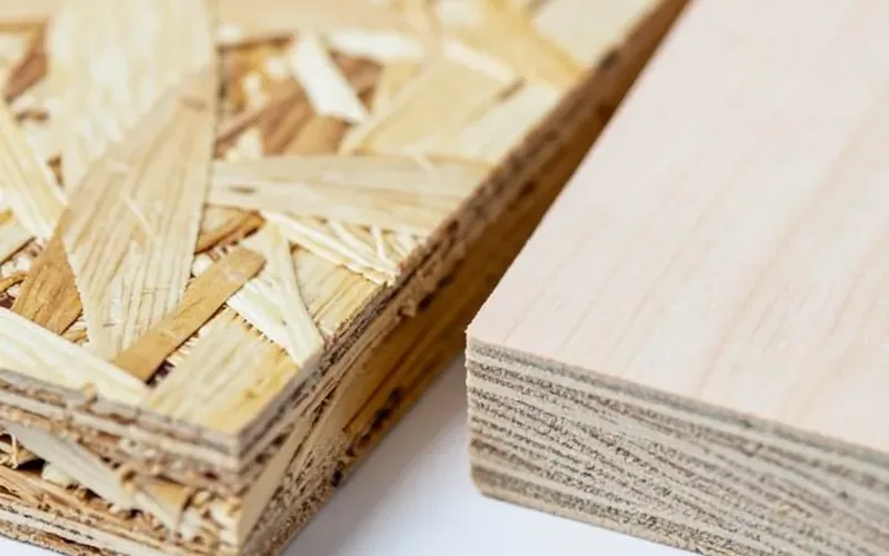 OSB strand board edge next to true plywood veneer layer edge for comparison OSB strand board edge next to true plywood veneer layer edge for comparison
