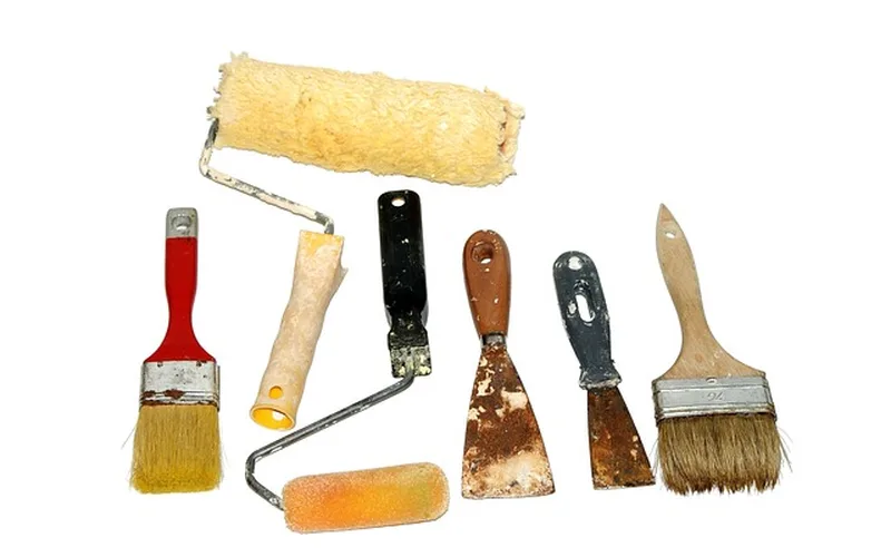 Brushes, rollers, and scrapers used to prep and finish particle board