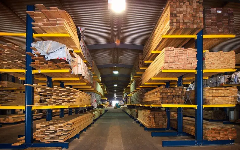 plywood sheets and lumber stacked at a building supply yard