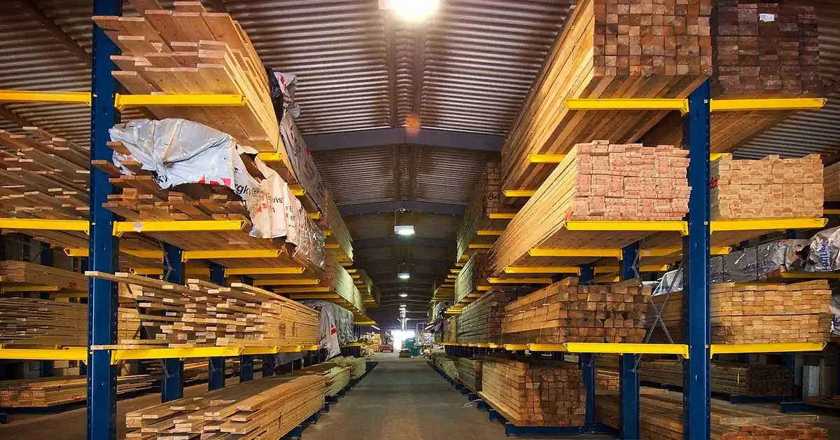 Stacked plywood sheets in a warehouse, the engineered wood material covered in this guide