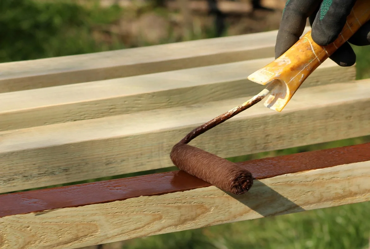 Applying primer to a wood surface with a roller