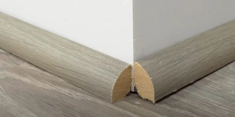 A mitered quarter round corner joint at a baseboard