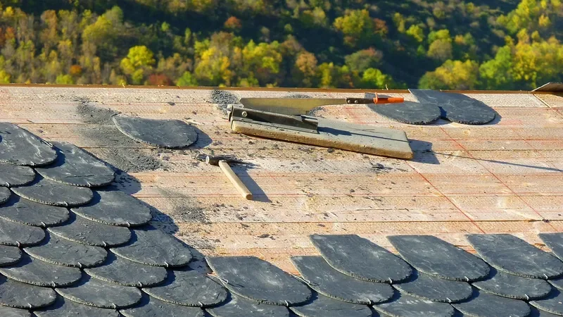 Roof deck partly covered with roofing while the underlayment and deck are still exposed Roof deck partly covered with roofing while the underlayment and deck are still exposed