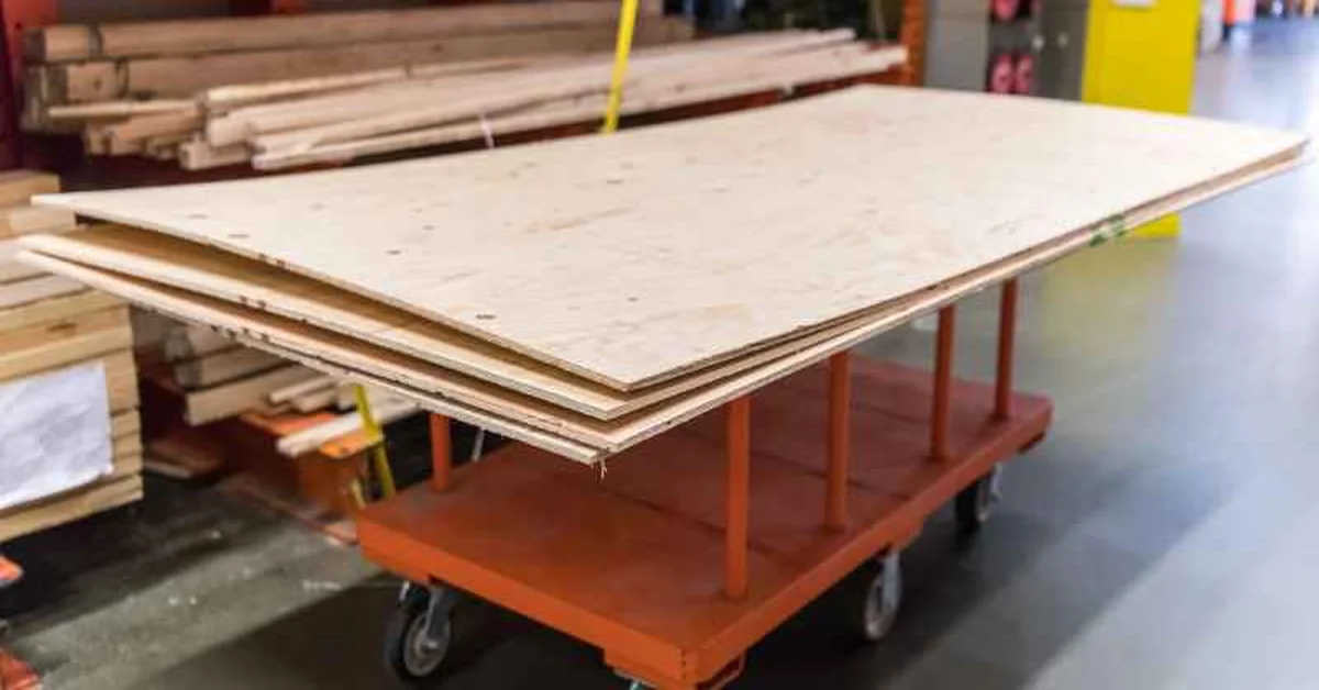 Stack of RTD plywood sheets on a cart at a building supply store
