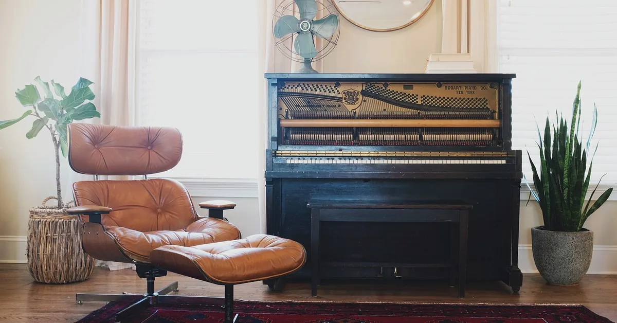 area rug laid over hardwood floor in a furnished living room with a rug pad underneath