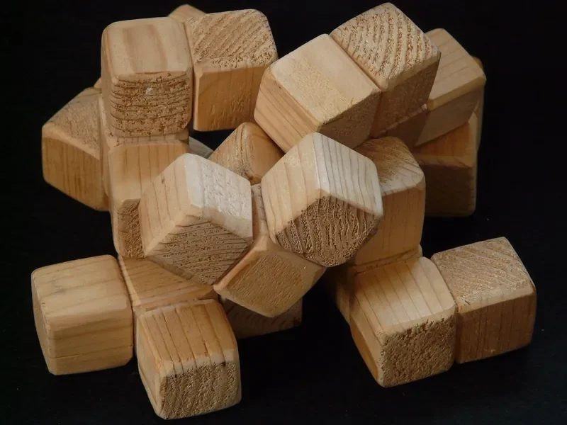 Pile of small square hardwood cubes cut from stock Pile of small square hardwood cubes cut from stock