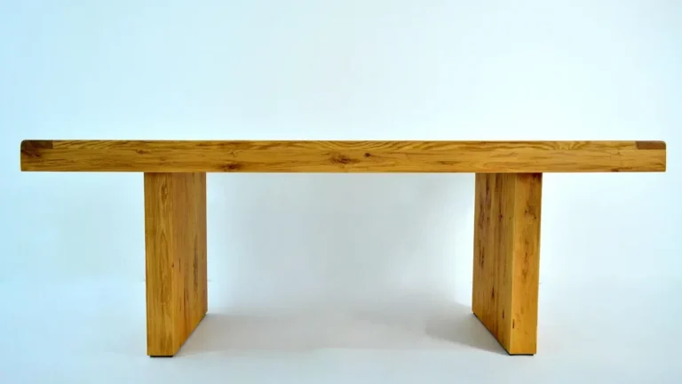 Solid oak bench with a clear natural finish on a plain background