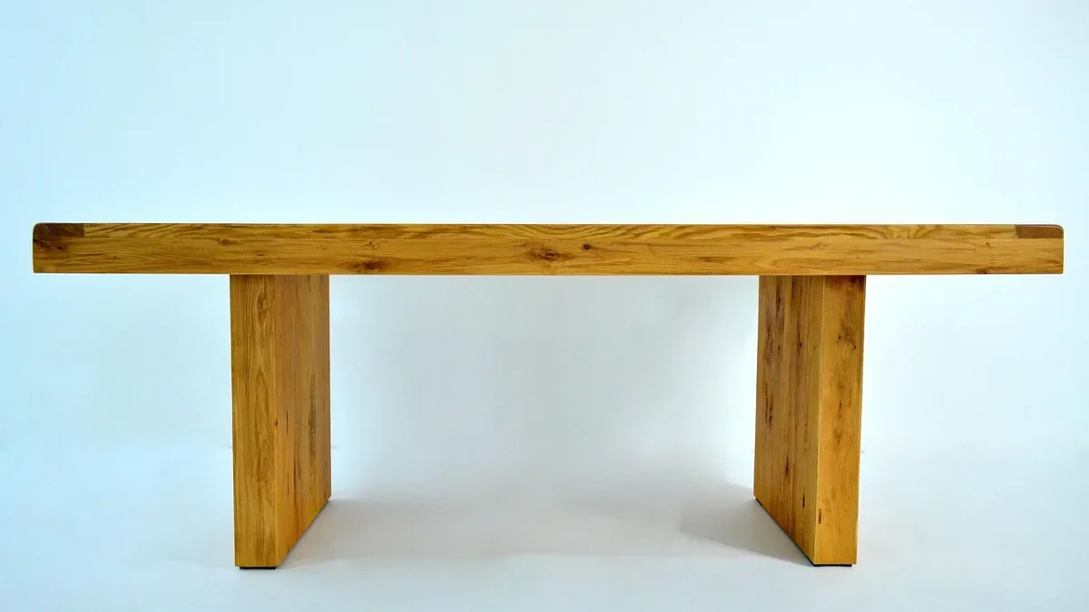 Solid oak bench with a clear natural finish on a plain background