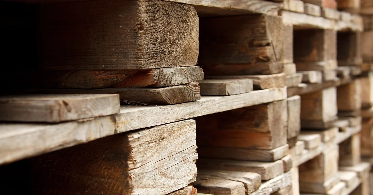 close-up of stacked wooden pallets showing wear and board condition