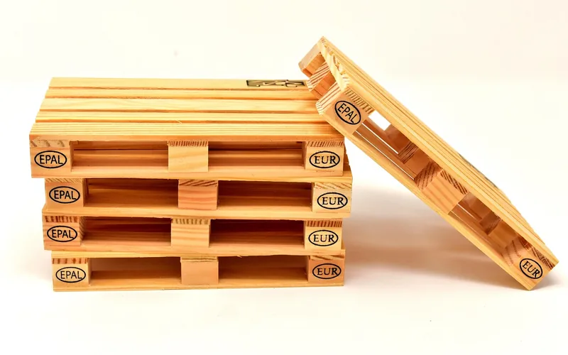 Small stack of stamped wooden pallets leaning against each other