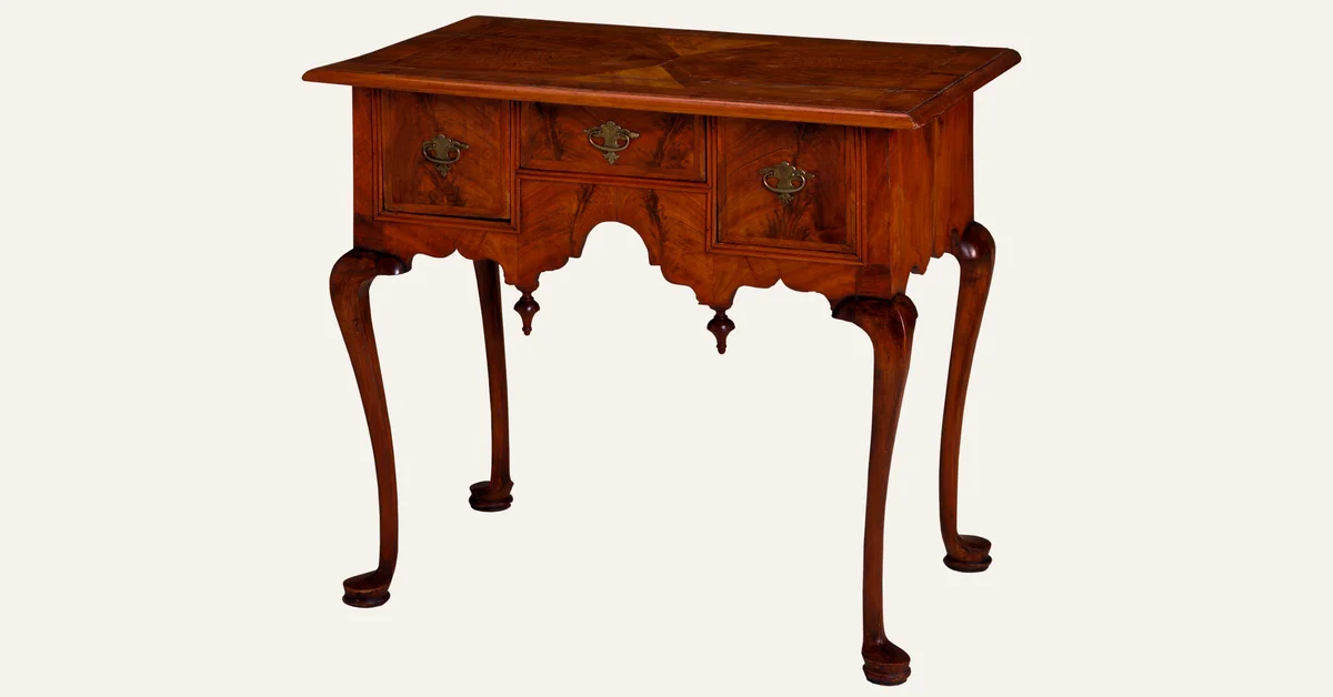 Antique walnut lowboy table with a shaped scalloped apron under the top between the cabriole legs