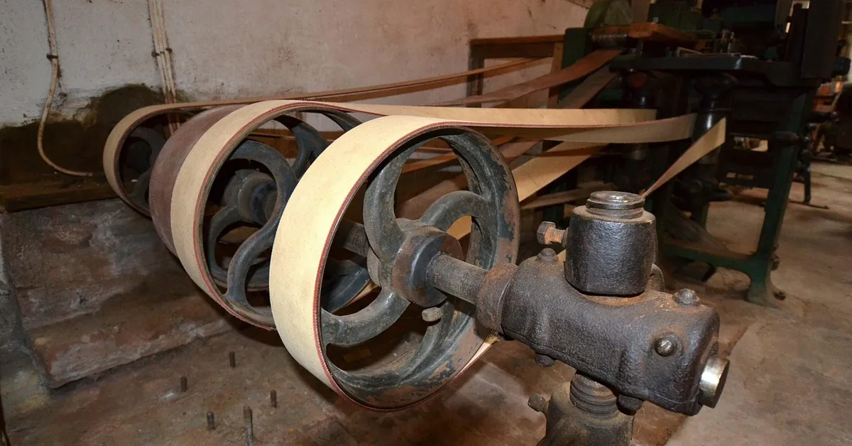 Thin wood veneer sheets wound around the rollers of a veneer splicing machine in a workshop Thin wood veneer sheets wound around the rollers of a veneer splicing machine in a workshop