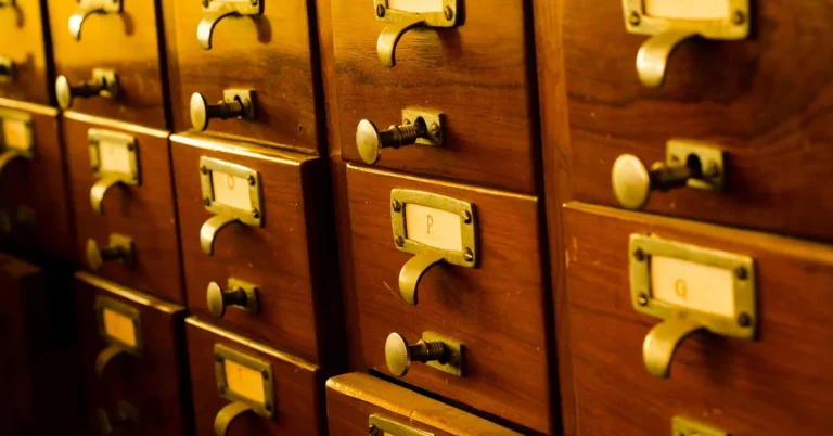 Rows of wooden drawers with brass pulls and label holders