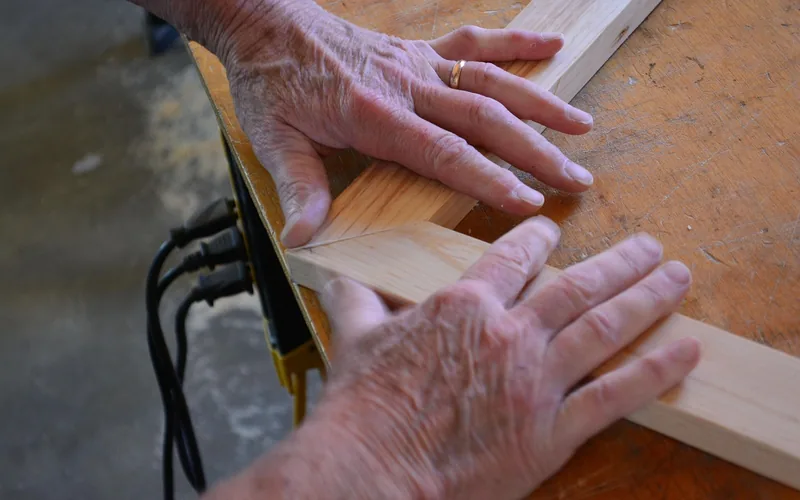 craftsman hands joining a wooden picture frame in a workshop