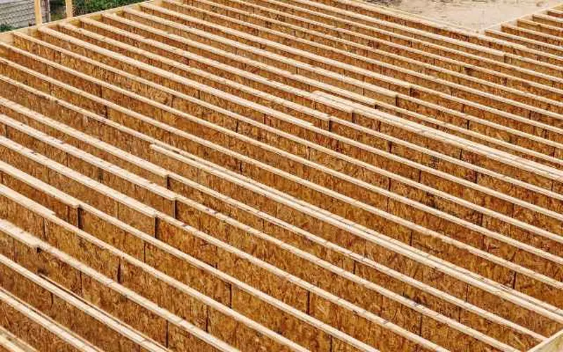 Overhead view of a wood-framed deck subfloor with joists spaced for standard decking