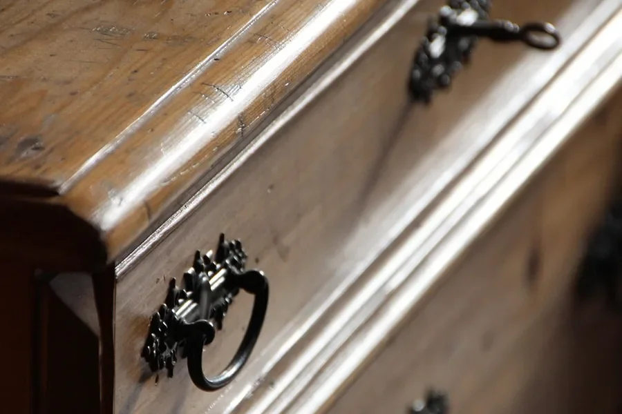 Antique wooden dresser with a warm, aged patina on the drawer fronts