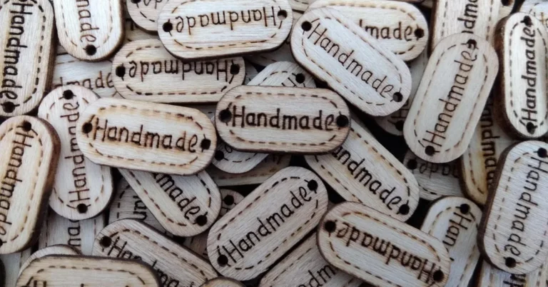 Wood burned designs and lettering on small pale wood tags