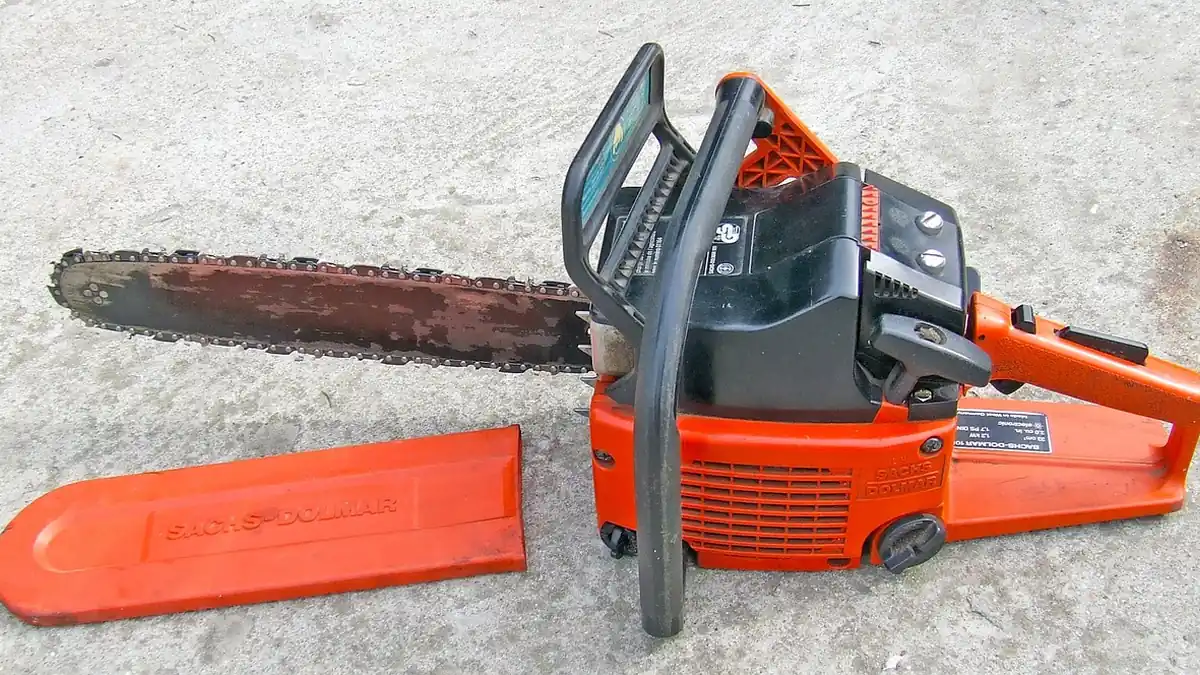 Filing lightly and often removes less metal than waiting for the chain to go blunt Chainsaw laid out for chain sharpening with a round file