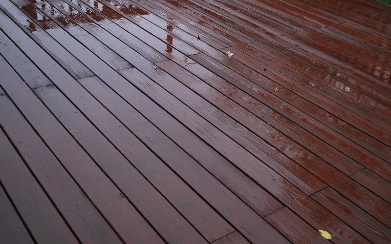 Coated wooden deck boards wet with rain