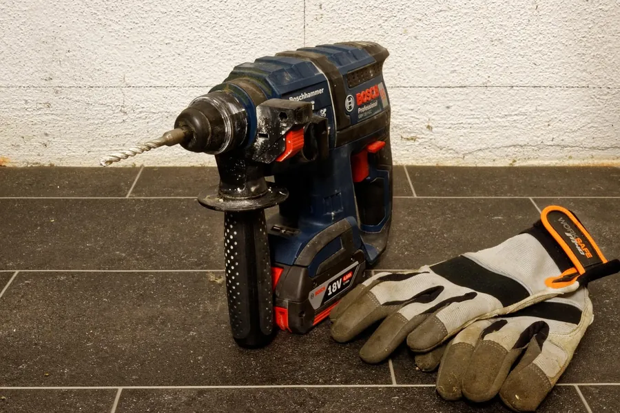 Cordless impact drill with battery pack at a construction jobsite