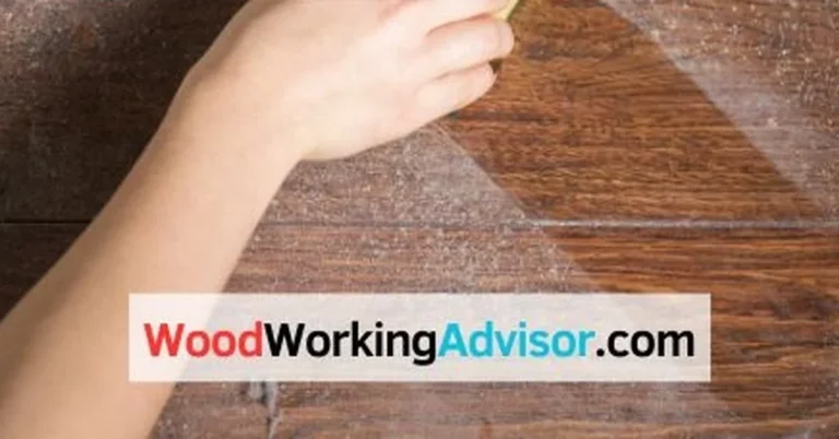 Wiping Danish oil residue off a wood floor with a cloth during removal