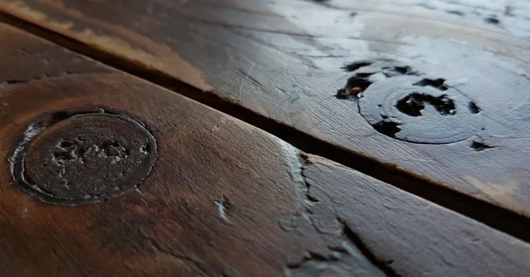 Dark brown stained wood boards with knots