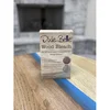 Dixie Belle Wood Bleach Kit two-part box standing on a stained wood tabletop