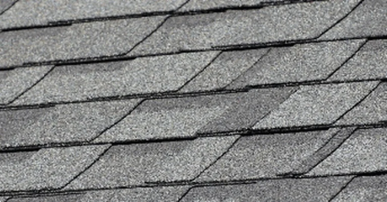 Close-up of gray-brown blended asphalt shingles similar to the Driftwood color
