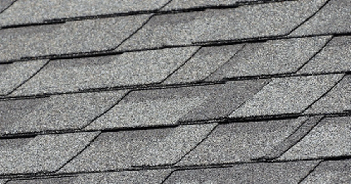 Close-up of gray-brown blended asphalt shingles similar to the Driftwood color