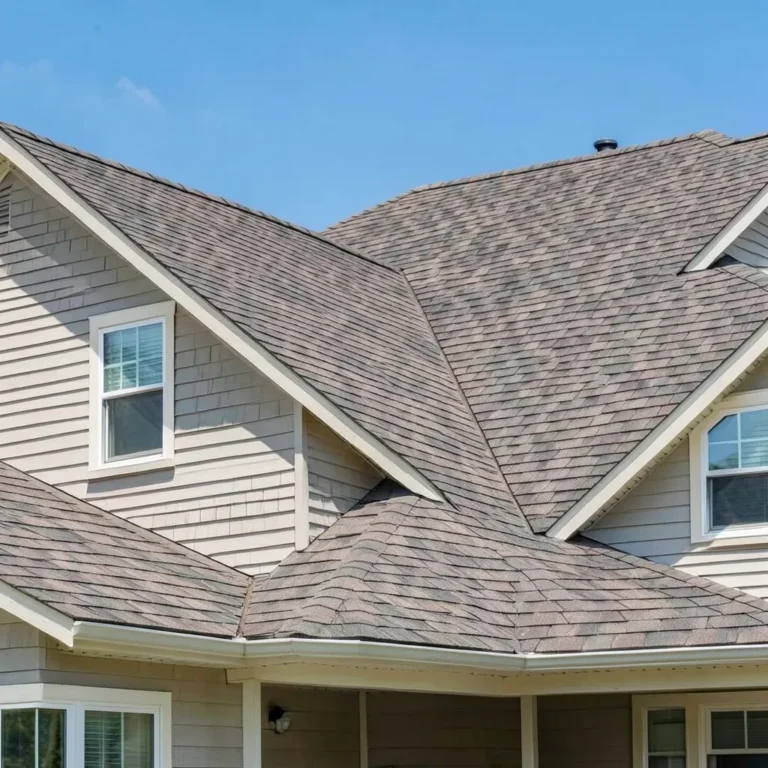 A house roof finished in driftwood-colored architectural asphalt shingles