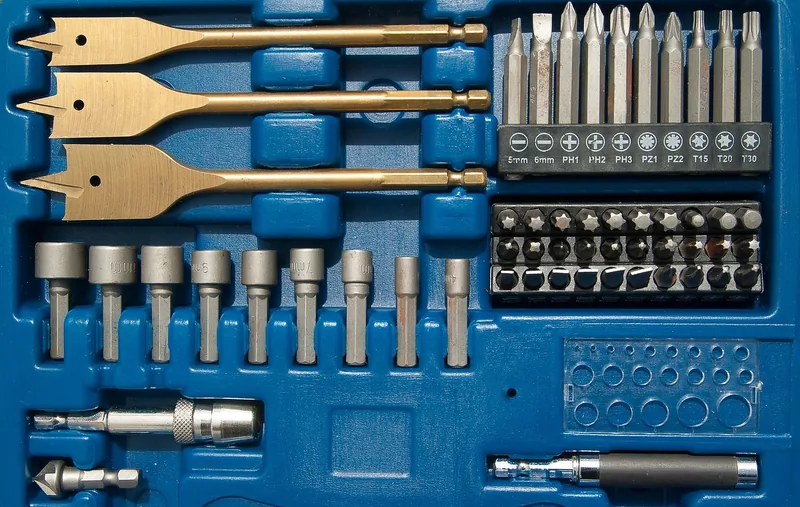 Drill and driver bit set with a countersink bit and spade bits in a case