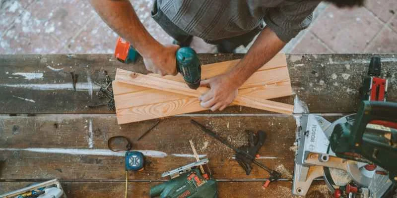 Drilling a pilot hole into a wood board