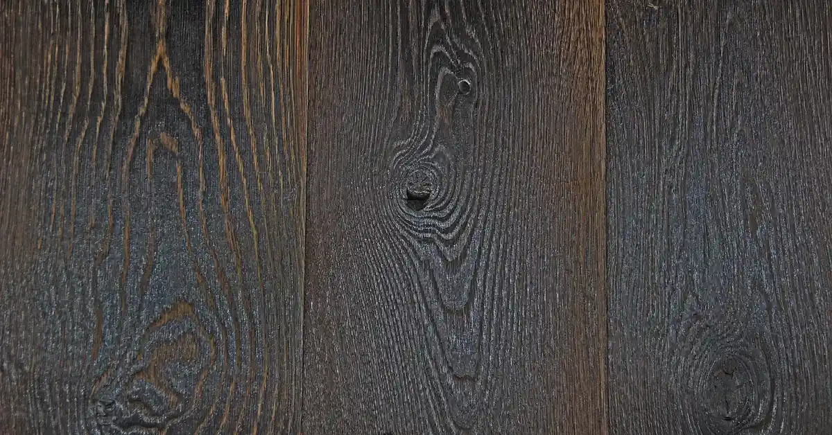 Near-black oak boards with the grain still visible through the dark finish