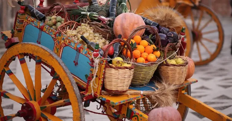 Decorative handmade wooden cart with large spoked wheels similar in build to a candy cart frame