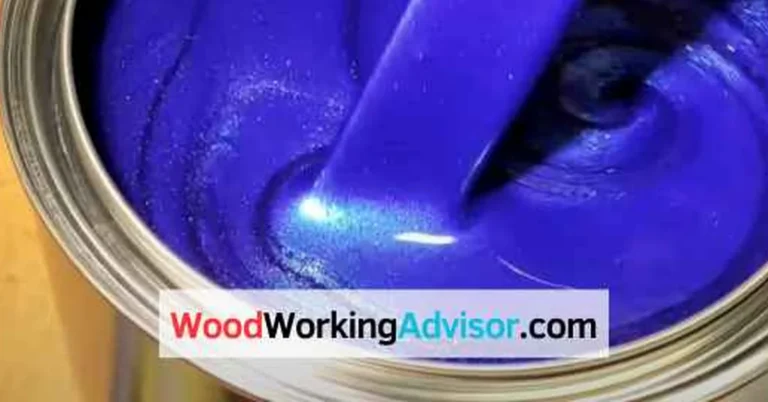Open gallon paint can with wet paint being stirred, illustrating typical gallon of paint weight