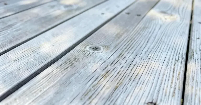 Close-up of a weathered silver-grey wood deck showing natural aging