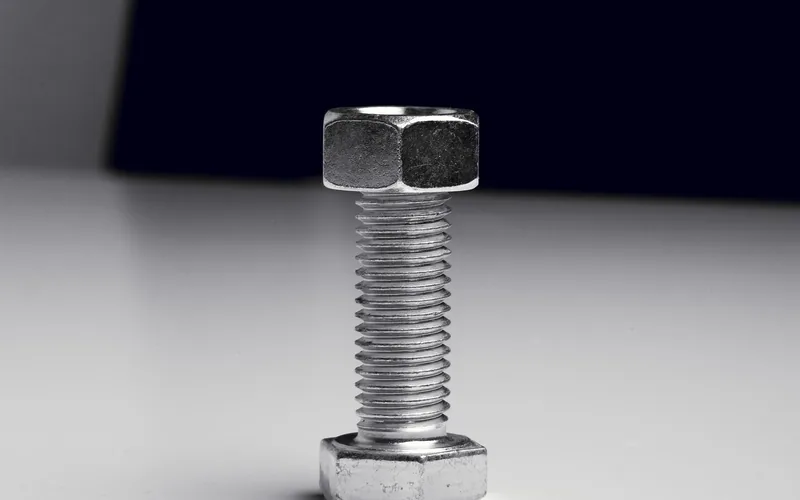 Close-up of a hex bolt and nut showing a standard right-hand thread pattern