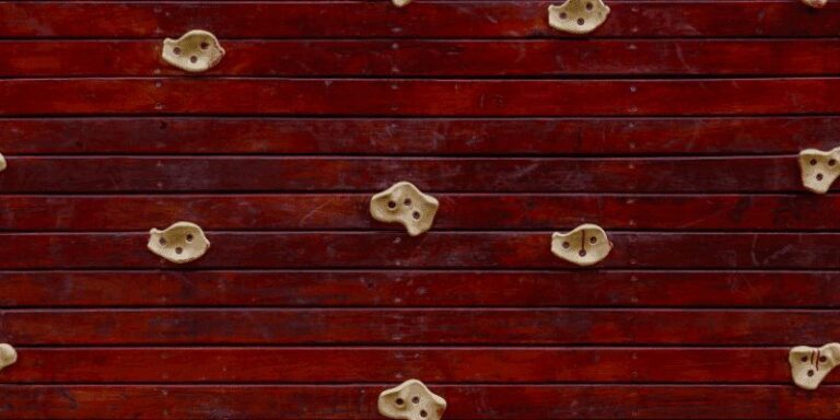 Finished wooden climbing hold mounted on a wall