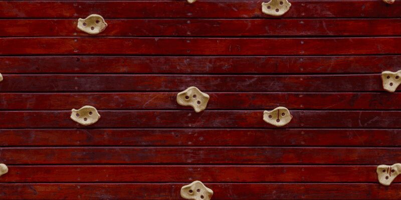 Finished wooden climbing hold mounted on a wall