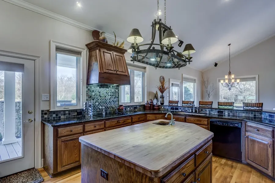 Kitchen with a slate tile backsplash and a butcher block island