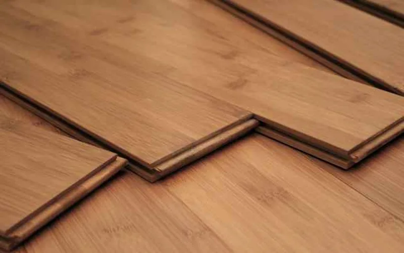 Sorted leftover hardwood flooring planks on a workshop table