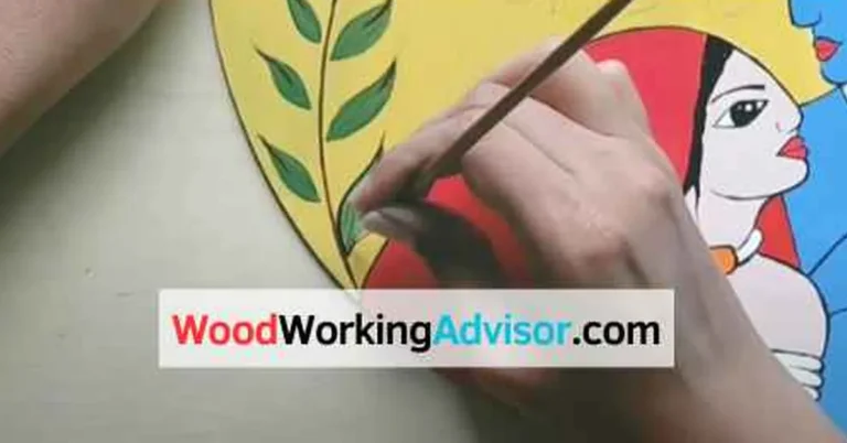 Hand painting a colorful mural design onto a round MDF board