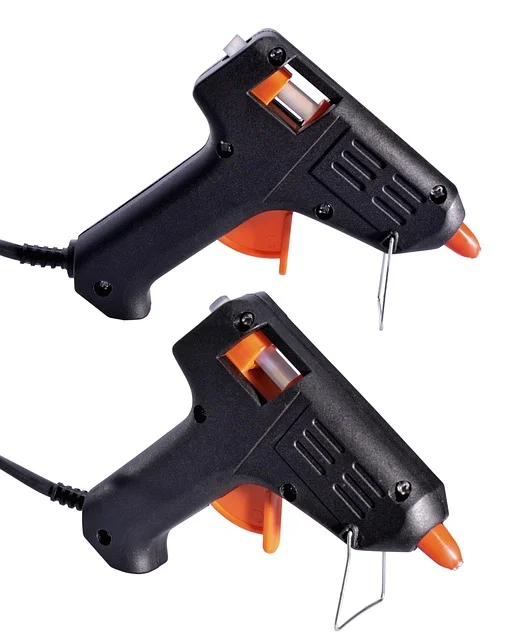 Two mini hot glue guns each loaded with a glue stick