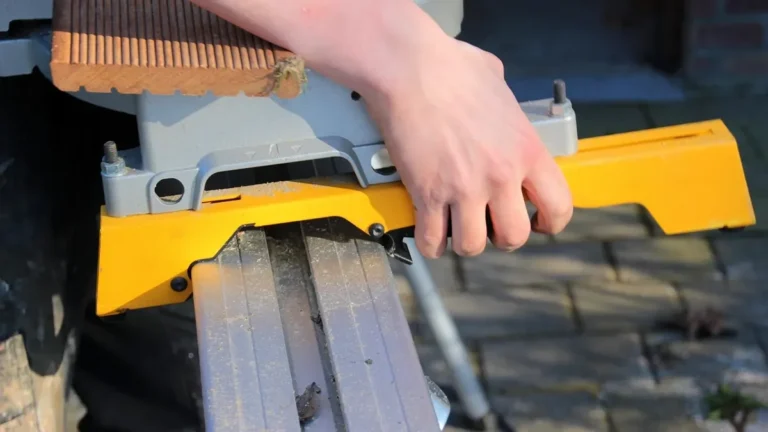Miter saw with a fold-out support arm holding a board level with the saw table