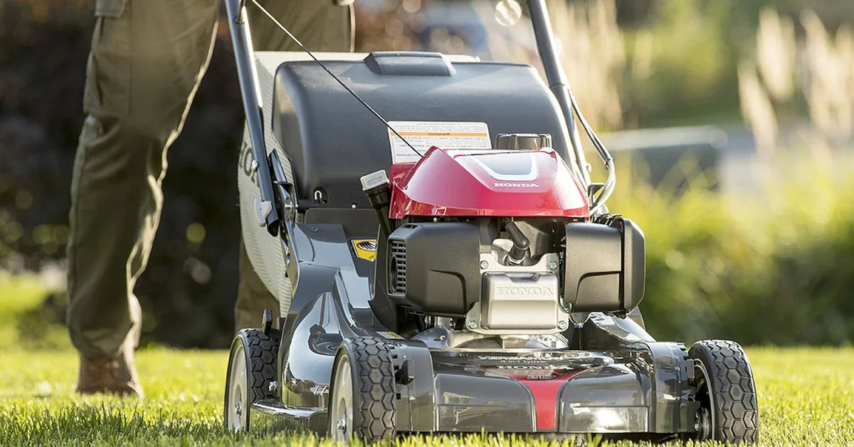 Honda push mower on grass, used to illustrate lawn mower blade bolt maintenance