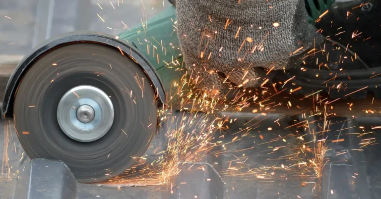angle grinder sharpening a metal blade edge with sparks flying