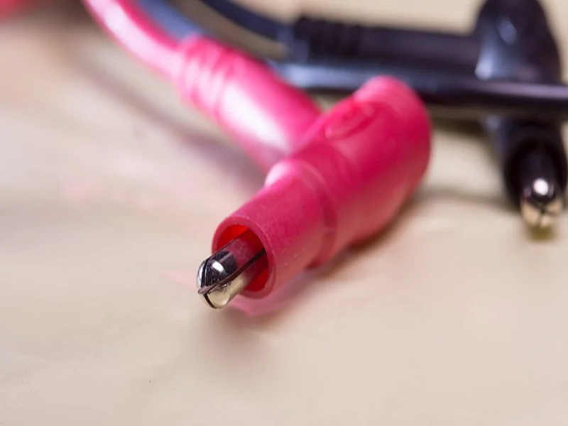 Multimeter probes used to test the voltage output of a battery pack